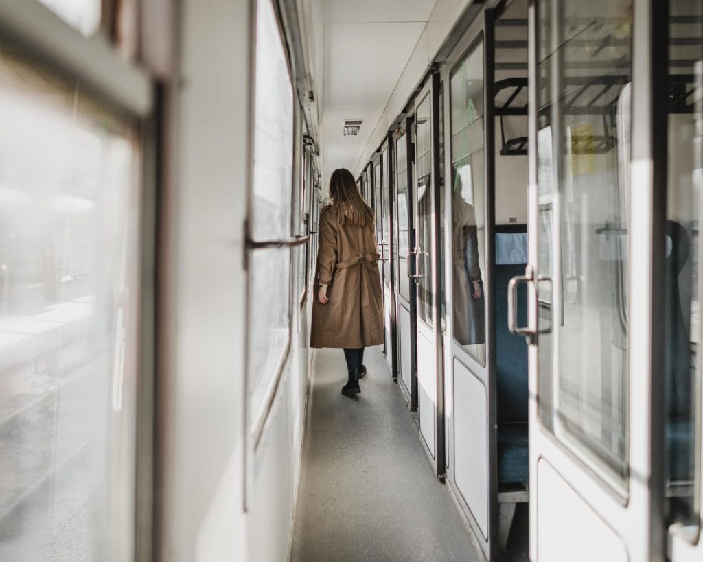 long-shot-woman-walking-train-corridor